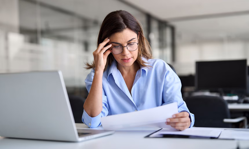 Female quality person in an office, reviewing documents