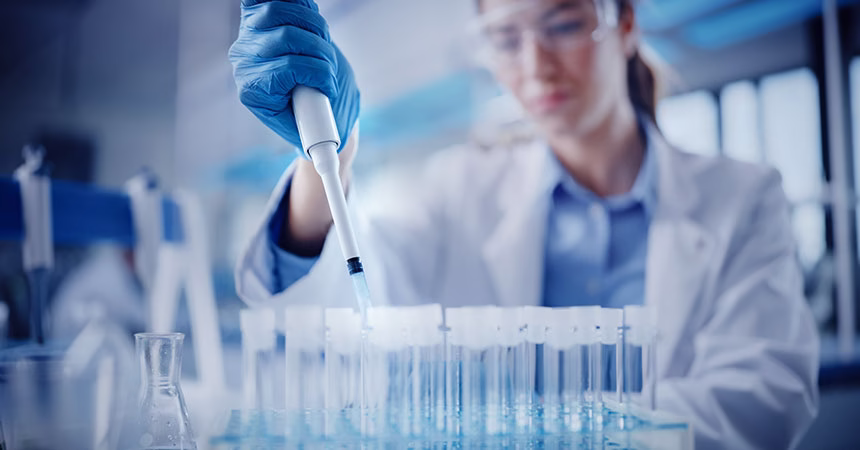 Female lab technician filling sample tubes